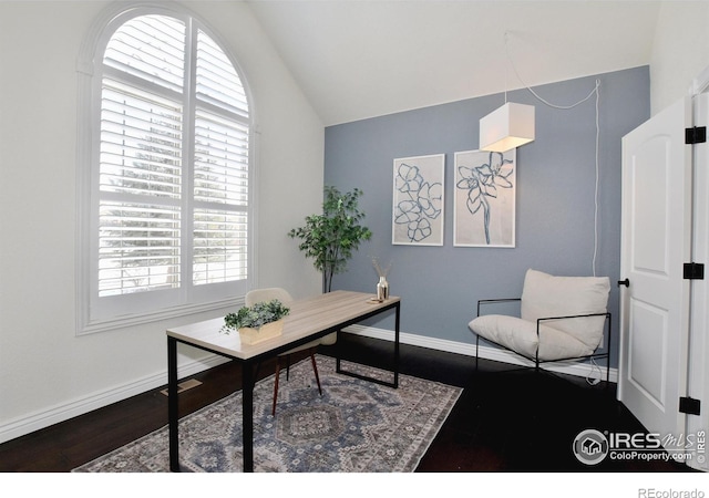 office space featuring lofted ceiling, dark wood-style floors, and baseboards