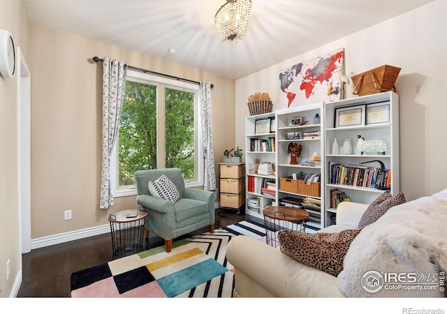 sitting room featuring dark wood-type flooring and baseboards