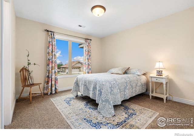 bedroom with carpet, visible vents, and baseboards