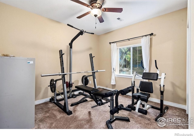 exercise room featuring ceiling fan, carpet, visible vents, and baseboards