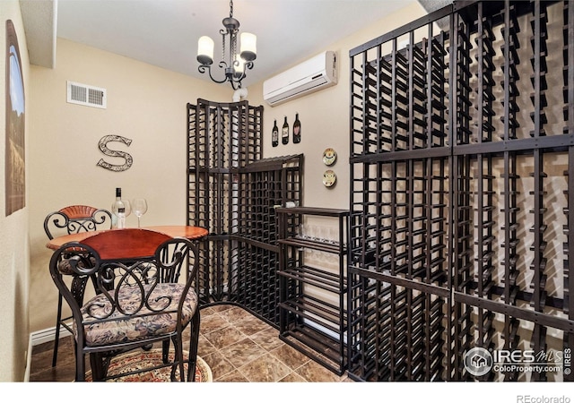 wine cellar featuring visible vents, a chandelier, and a wall mounted AC