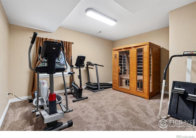 workout room with carpet floors and baseboards