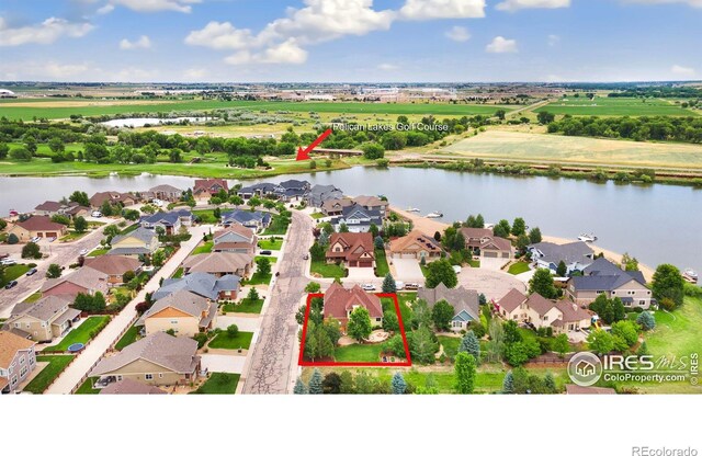 bird's eye view featuring a water view and a residential view