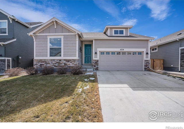 craftsman-style home with board and batten siding, a front yard, stone siding, and a garage