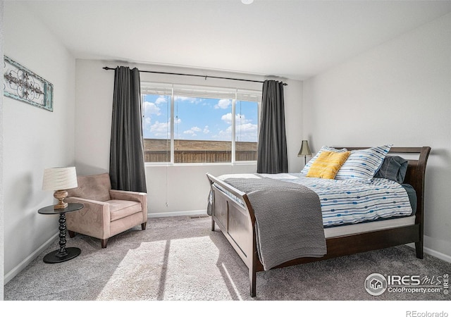 carpeted bedroom with baseboards