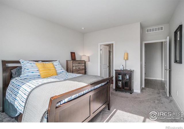 carpeted bedroom with visible vents and baseboards