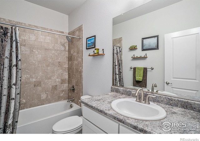 full bathroom featuring toilet, shower / bath combo, and vanity