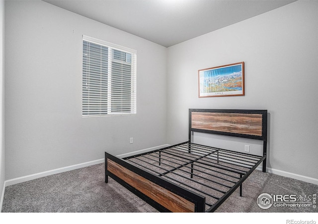 carpeted bedroom with baseboards