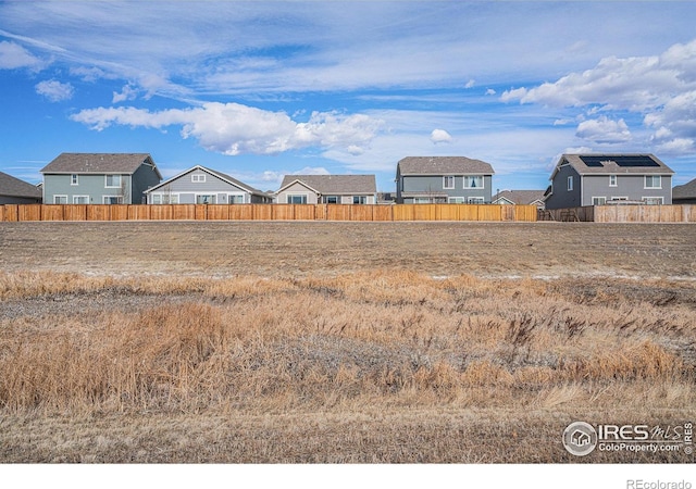 view of yard featuring a residential view and fence