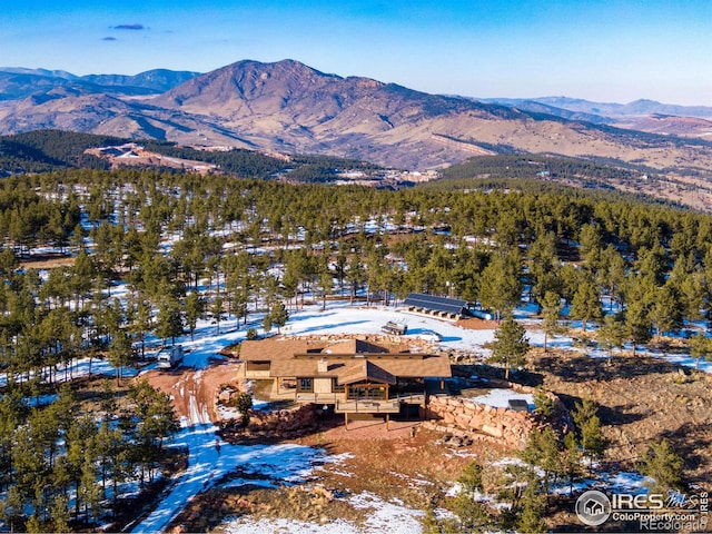 snowy aerial view with a mountain view