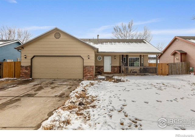 single story home with a garage, driveway, fence, a porch, and brick siding