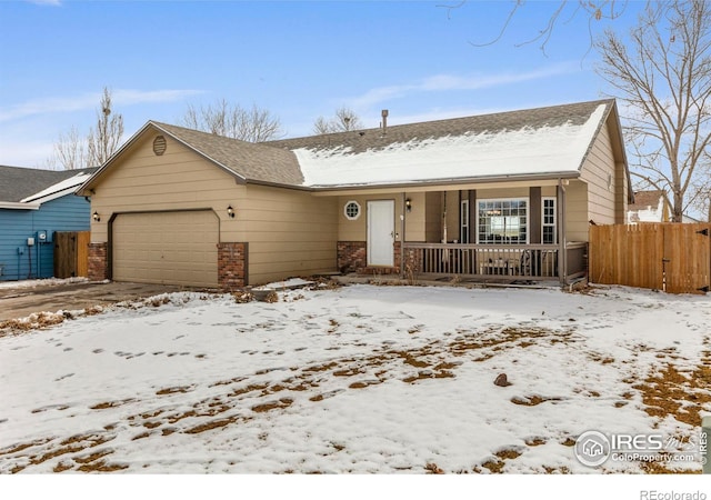 ranch-style home featuring covered porch, brick siding, fence, and an attached garage