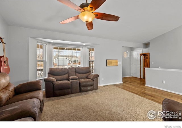 326 Riviera Ln, Johnstown, CO 80534 - living area featuring a ceiling fan, carpet floors, baseboards, and wood finished floors