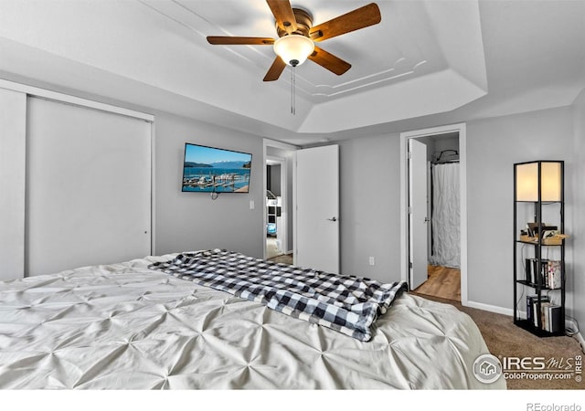 326 Riviera Ln, Johnstown, CO 80534 - bedroom featuring a tray ceiling, a closet, ceiling fan, and carpet flooring