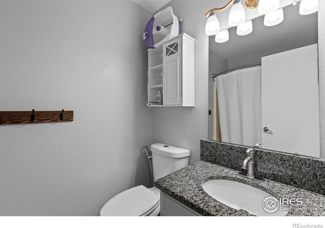 326 Riviera Ln, Johnstown, CO 80534 - bathroom featuring toilet, vanity, and a textured wall