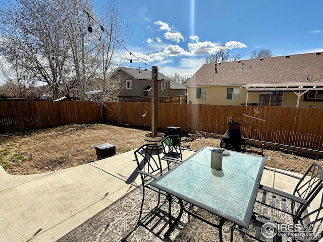 326 Riviera Ln, Johnstown, CO 80534 - view of patio featuring a fenced backyard and outdoor dining space