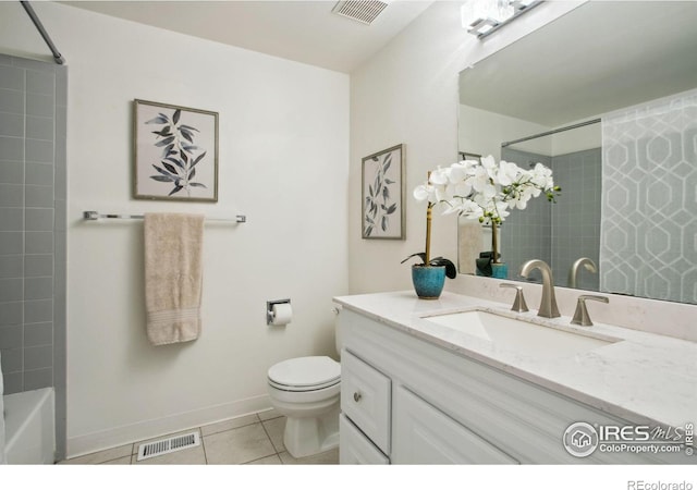 bathroom with toilet, vanity, visible vents, and tile patterned floors