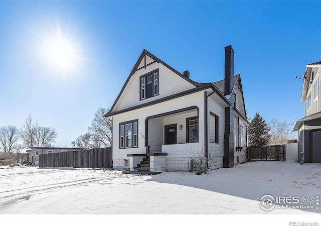 view of front of property featuring a chimney and fence