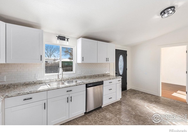 kitchen featuring stainless steel dishwasher, plenty of natural light, a sink, and white cabinetry