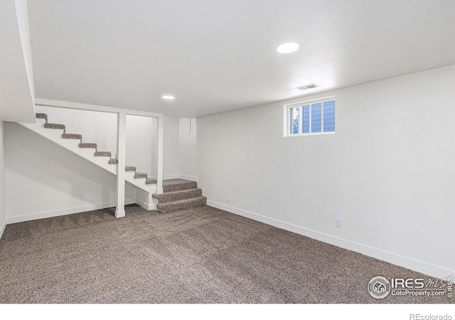 basement featuring baseboards, visible vents, stairway, carpet flooring, and recessed lighting