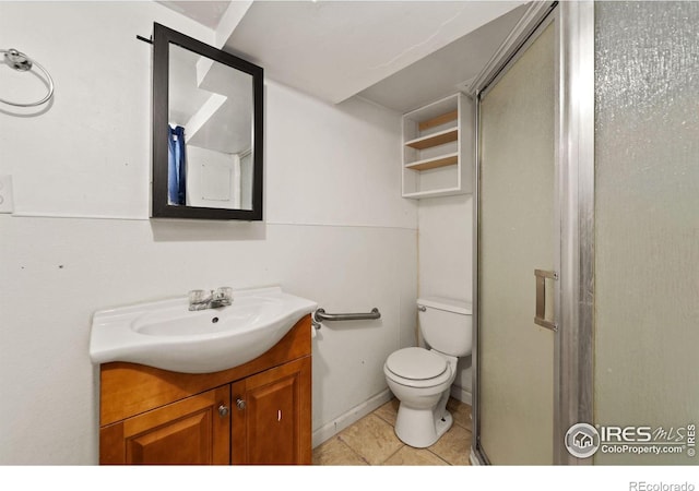 bathroom with tile patterned flooring, vanity, toilet, and walk in shower