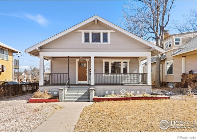 bungalow-style house featuring fence and a porch