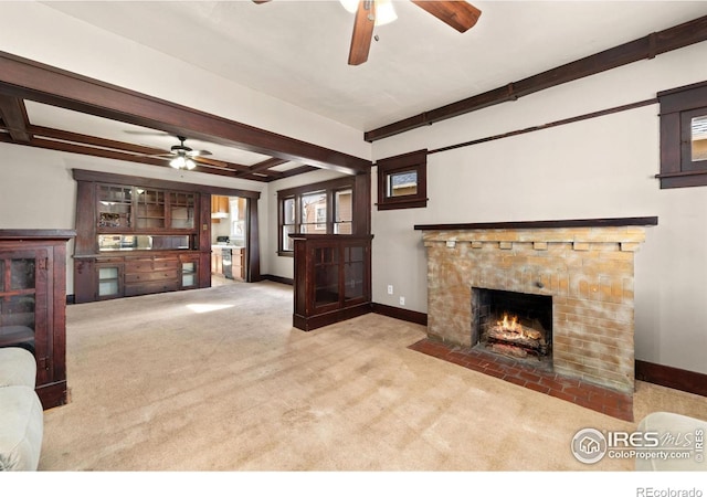 carpeted living room with ceiling fan, a fireplace with flush hearth, beam ceiling, and baseboards