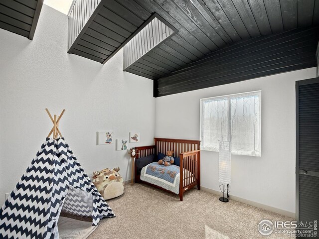 bedroom with wooden ceiling, baseboards, and carpet flooring