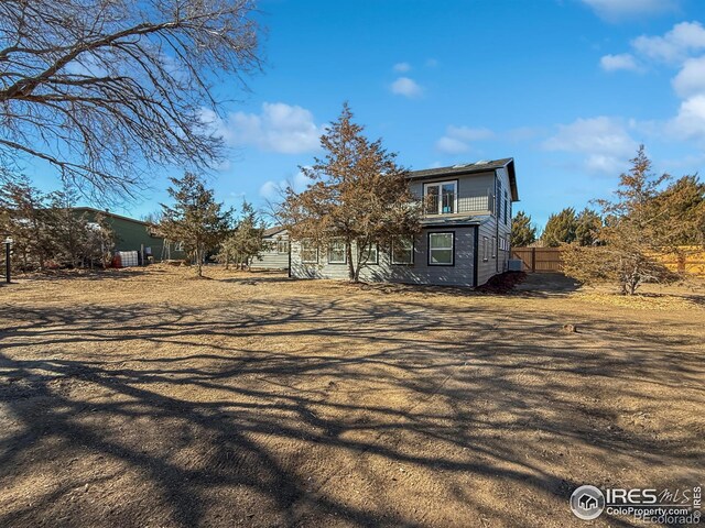 view of home's exterior with fence