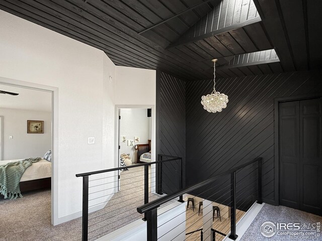 stairway featuring wood ceiling and a chandelier