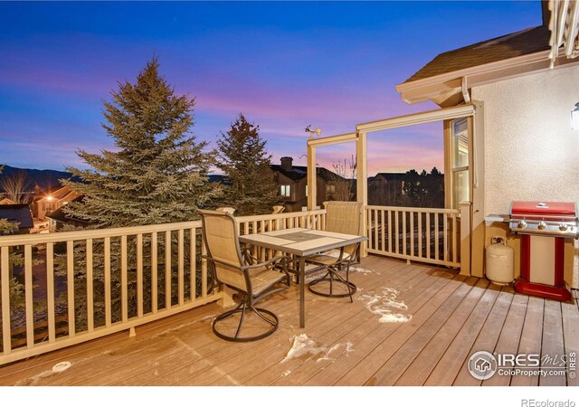 2185 Diamond Creek Dr, Colorado Springs, CO 80921 - deck at dusk with outdoor dining area and grilling area