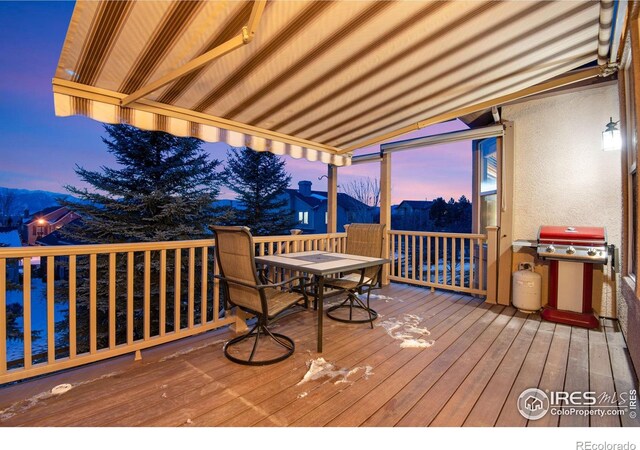 2185 Diamond Creek Dr, Colorado Springs, CO 80921 - deck at dusk featuring grilling area and outdoor dining space