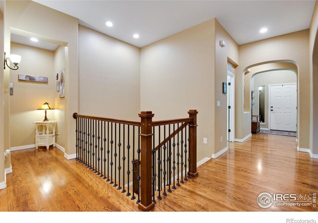2185 Diamond Creek Dr, Colorado Springs, CO 80921 - corridor with light wood-type flooring, baseboards, arched walkways, and recessed lighting
