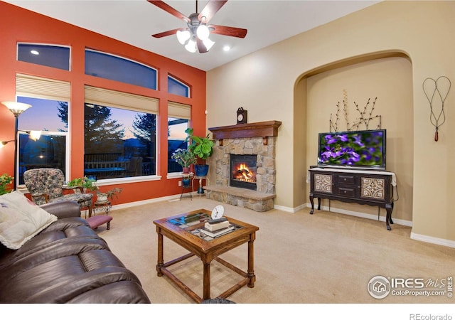 2185 Diamond Creek Dr, Colorado Springs, CO 80921 - living room with a ceiling fan, carpet flooring, a stone fireplace, and baseboards