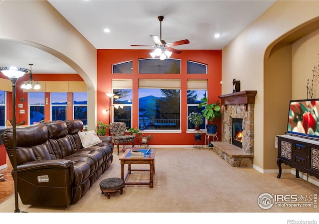 2185 Diamond Creek Dr, Colorado Springs, CO 80921 - carpeted living room with baseboards, ceiling fan with notable chandelier, vaulted ceiling, a fireplace, and recessed lighting