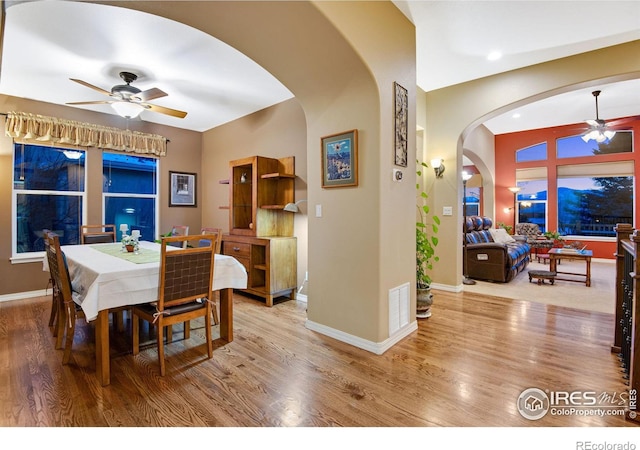 2185 Diamond Creek Dr, Colorado Springs, CO 80921 - dining area featuring a ceiling fan, arched walkways, visible vents, and wood finished floors