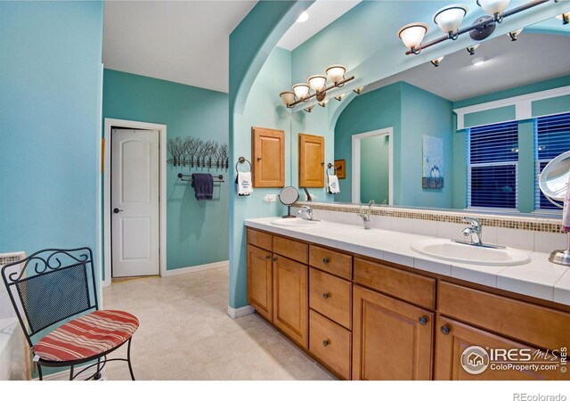 2185 Diamond Creek Dr, Colorado Springs, CO 80921 - bathroom featuring double vanity, a sink, and baseboards
