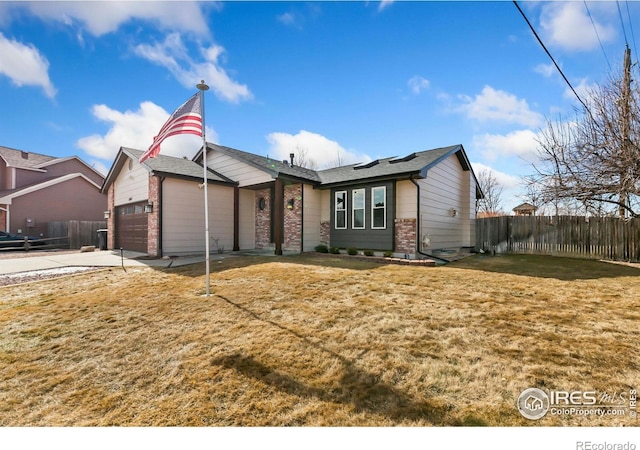 ranch-style house featuring a garage, brick siding, fence, driveway, and a front lawn