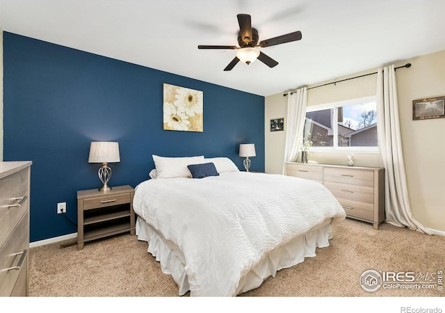 bedroom with light carpet, baseboards, and a ceiling fan