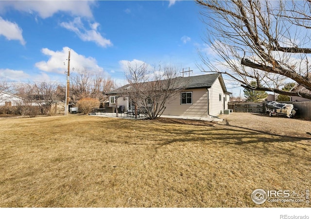 view of property exterior featuring central air condition unit, a patio area, fence, and a yard