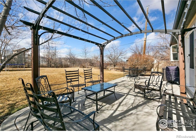 view of patio / terrace featuring outdoor dining space, a trampoline, and a pergola