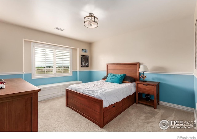 bedroom with carpet floors and visible vents