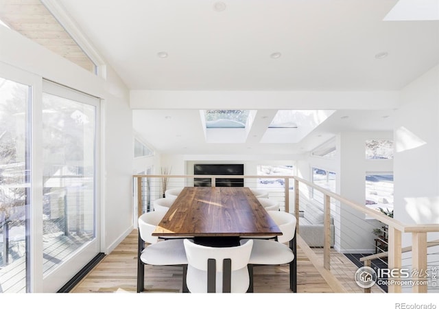 dining room featuring light wood-style floors, lofted ceiling, and recessed lighting