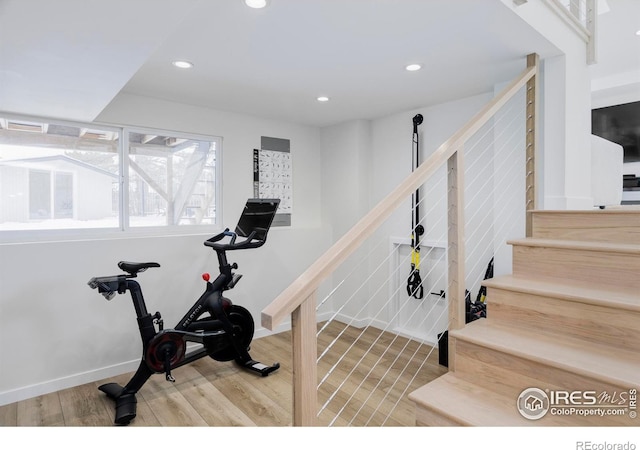 workout room featuring baseboards, wood finished floors, and recessed lighting