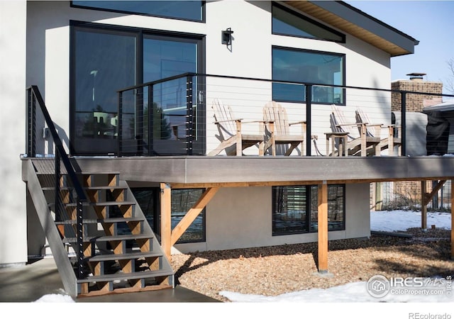 exterior space with stairs and stucco siding