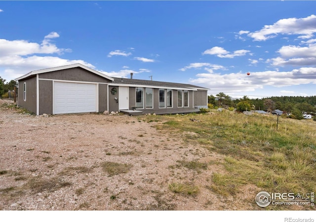 view of front of house featuring driveway, an attached garage, and stucco siding