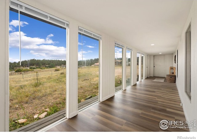 unfurnished sunroom featuring a rural view and plenty of natural light