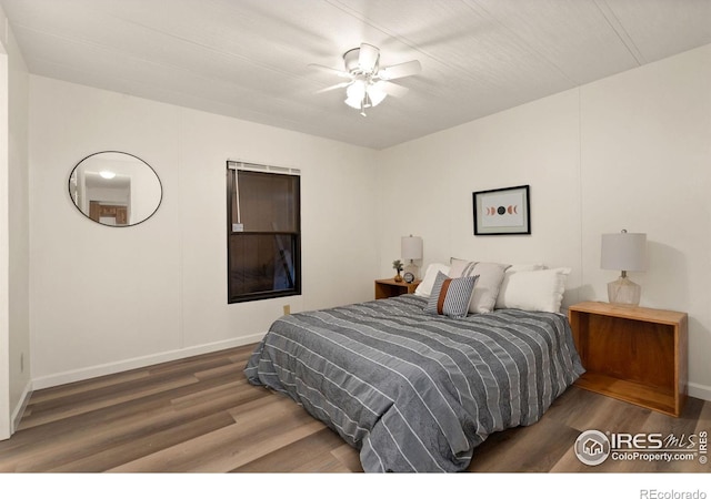 bedroom featuring dark wood-style floors, baseboards, and a ceiling fan