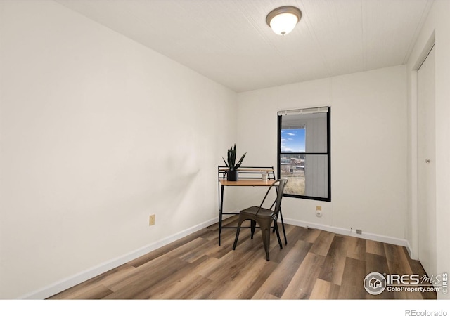 office area featuring baseboards and wood finished floors