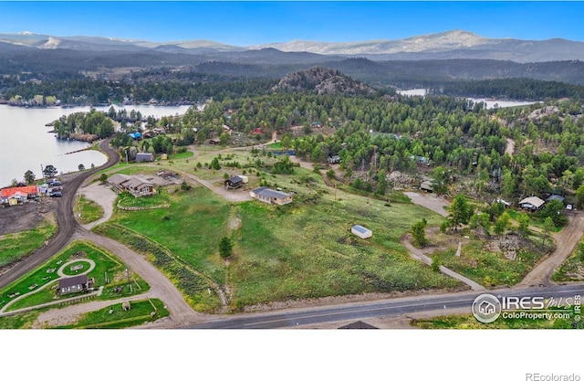 birds eye view of property with a water and mountain view